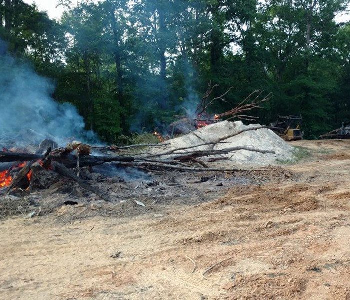 DeBord & Son Construction | clearing trees and debris from a site surrounded by trees